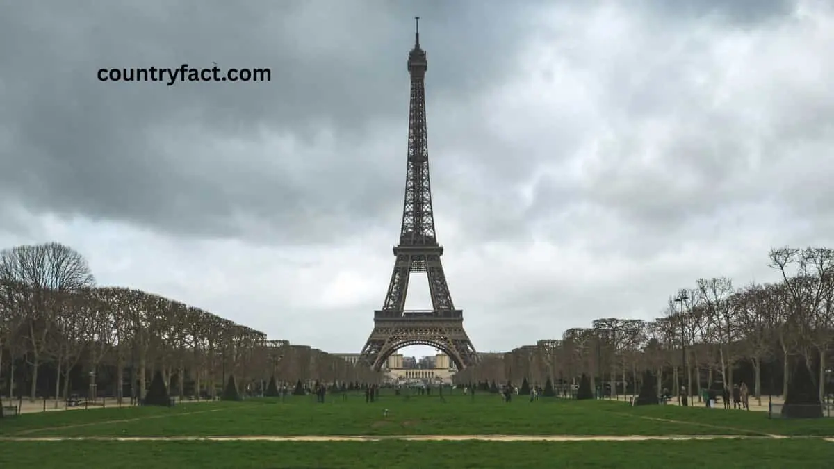 Tourists gathering at the base of the Eiffel Tower in Paris, France — one of the most popular spots related to interesting facts in France.